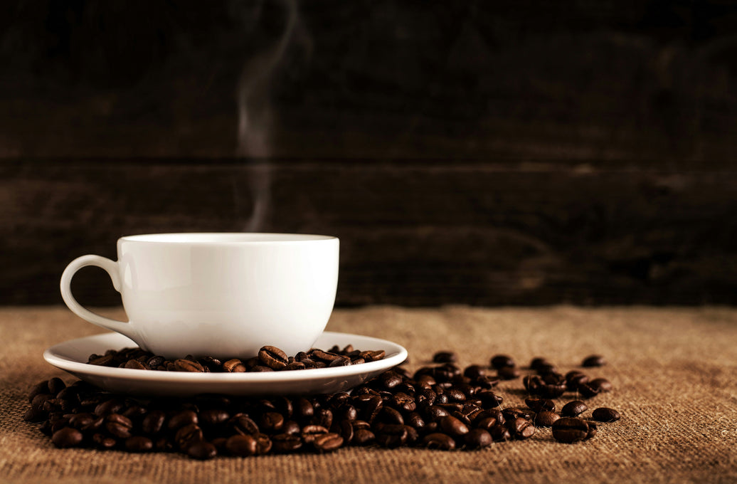 Freshly brewed coffee and roasted coffee beans representing naturally occurring coffee antioxidants