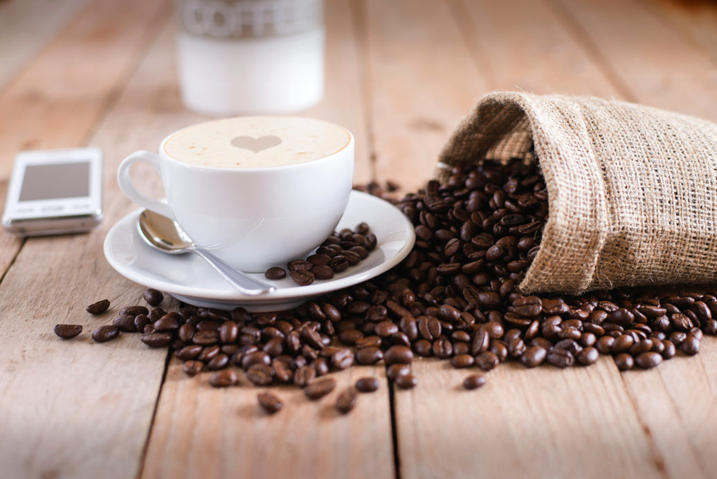 Freshly brewed coffee and roasted coffee beans for an article about coffee health benefits